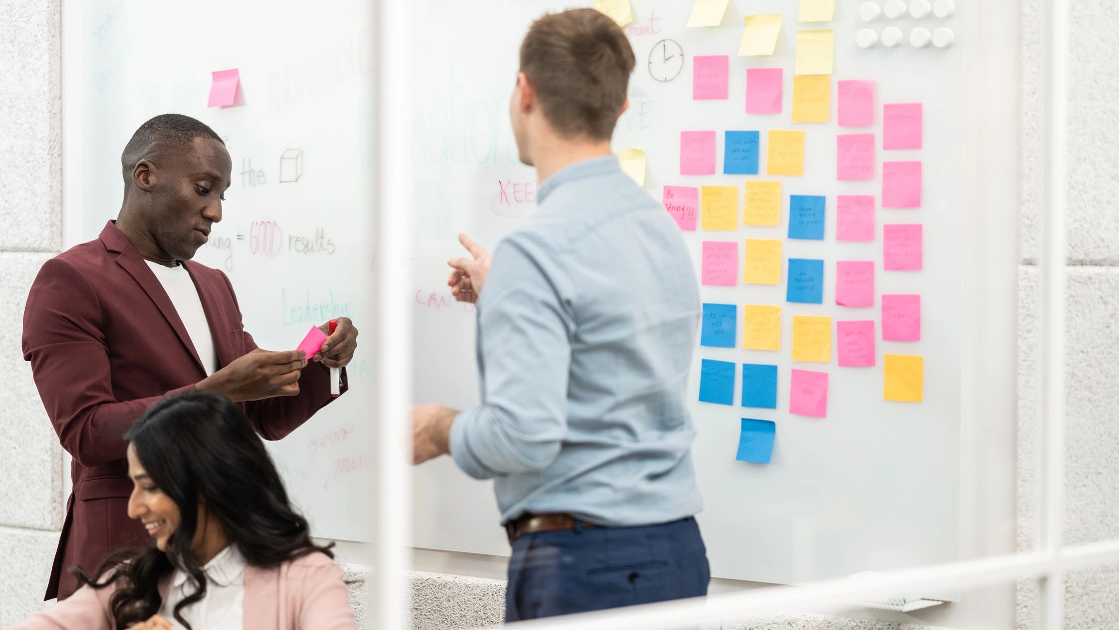 Team brainstorming with sticky notes on a planning board